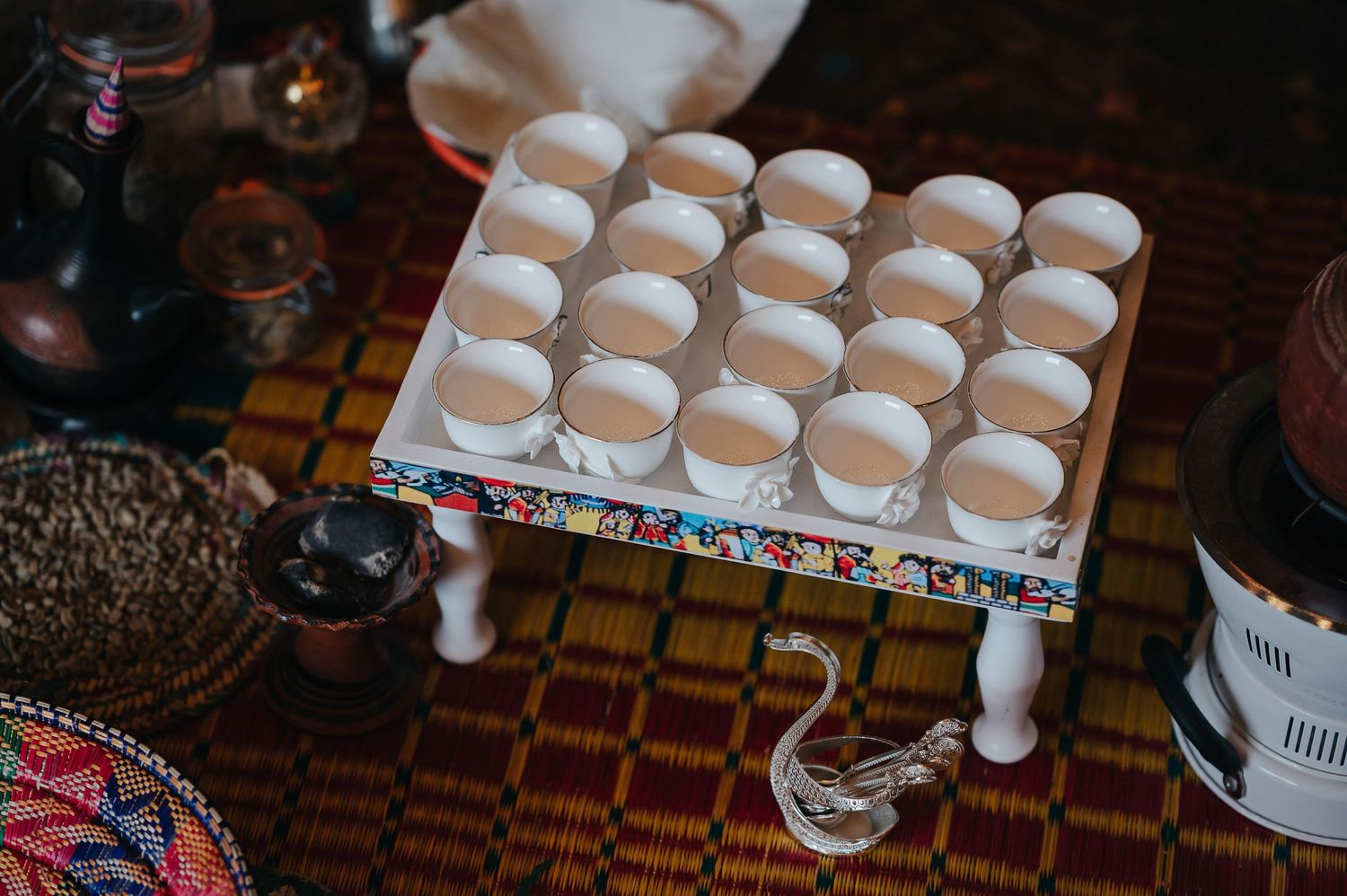 White macarons displayed on a decorative stand at a wedding dessert table.
