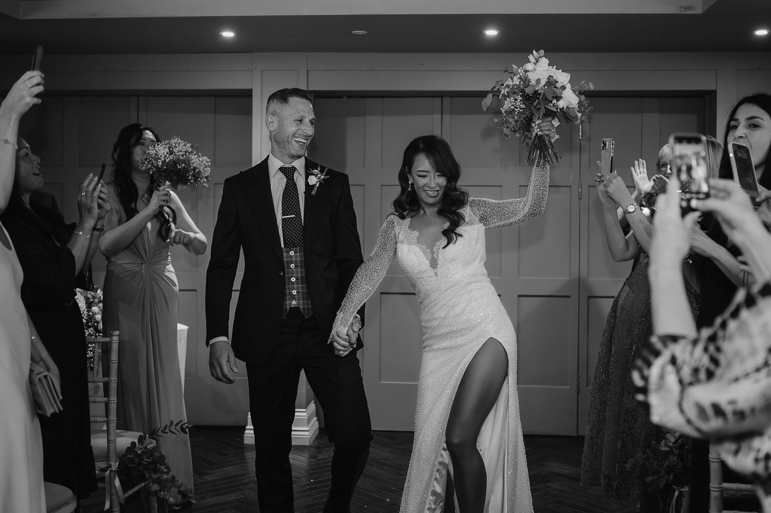 A celebratory entrance of newlyweds at their wedding reception.
