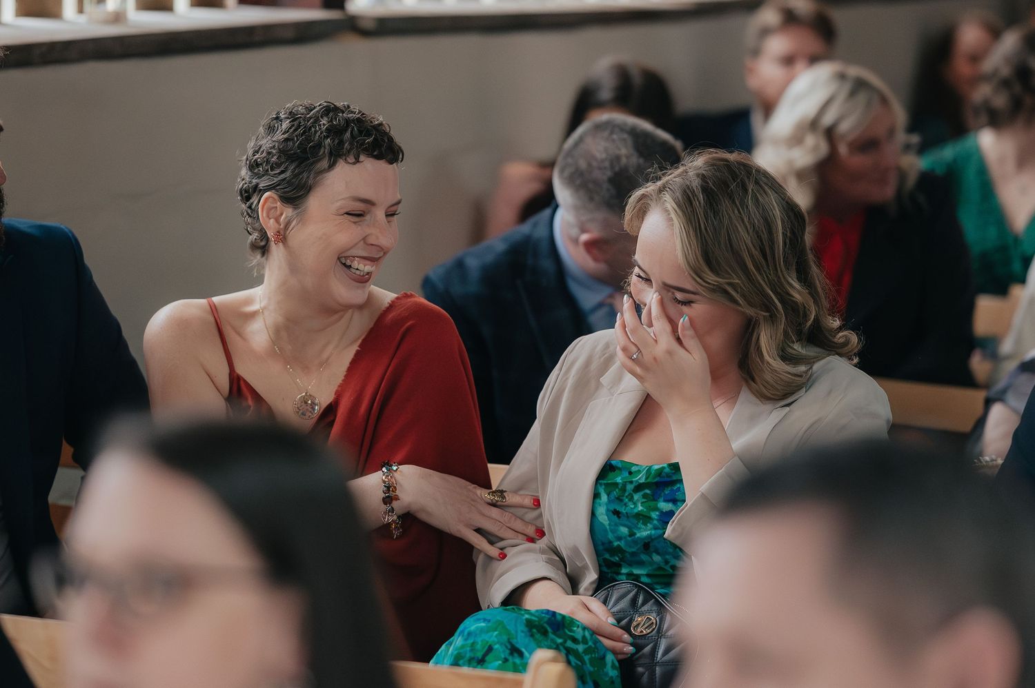 Guests share an emotional moment during a wedding reception celebration.