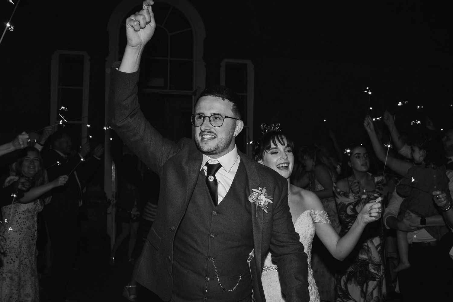 A celebratory moment on the dance floor at an evening wedding reception.