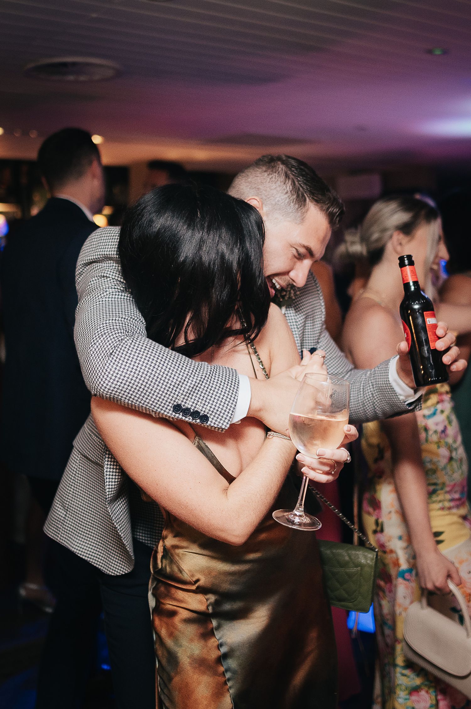 Party guests sharing an intimate dance moment at a reception.