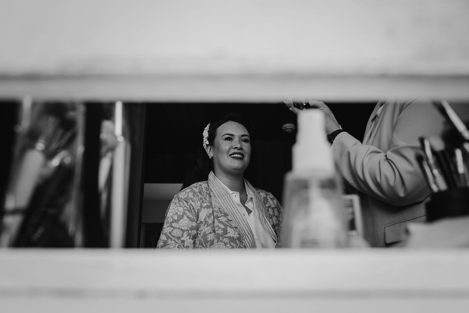 Black and white candid shot through a window showing joyful expressions.