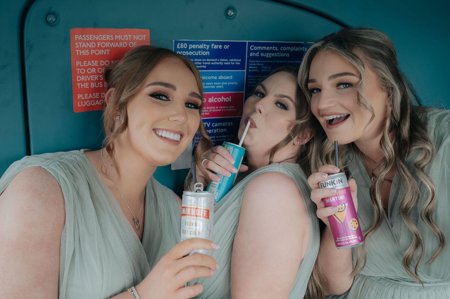 Friends sharing drinks and smiles in a turquoise-tinted setting.