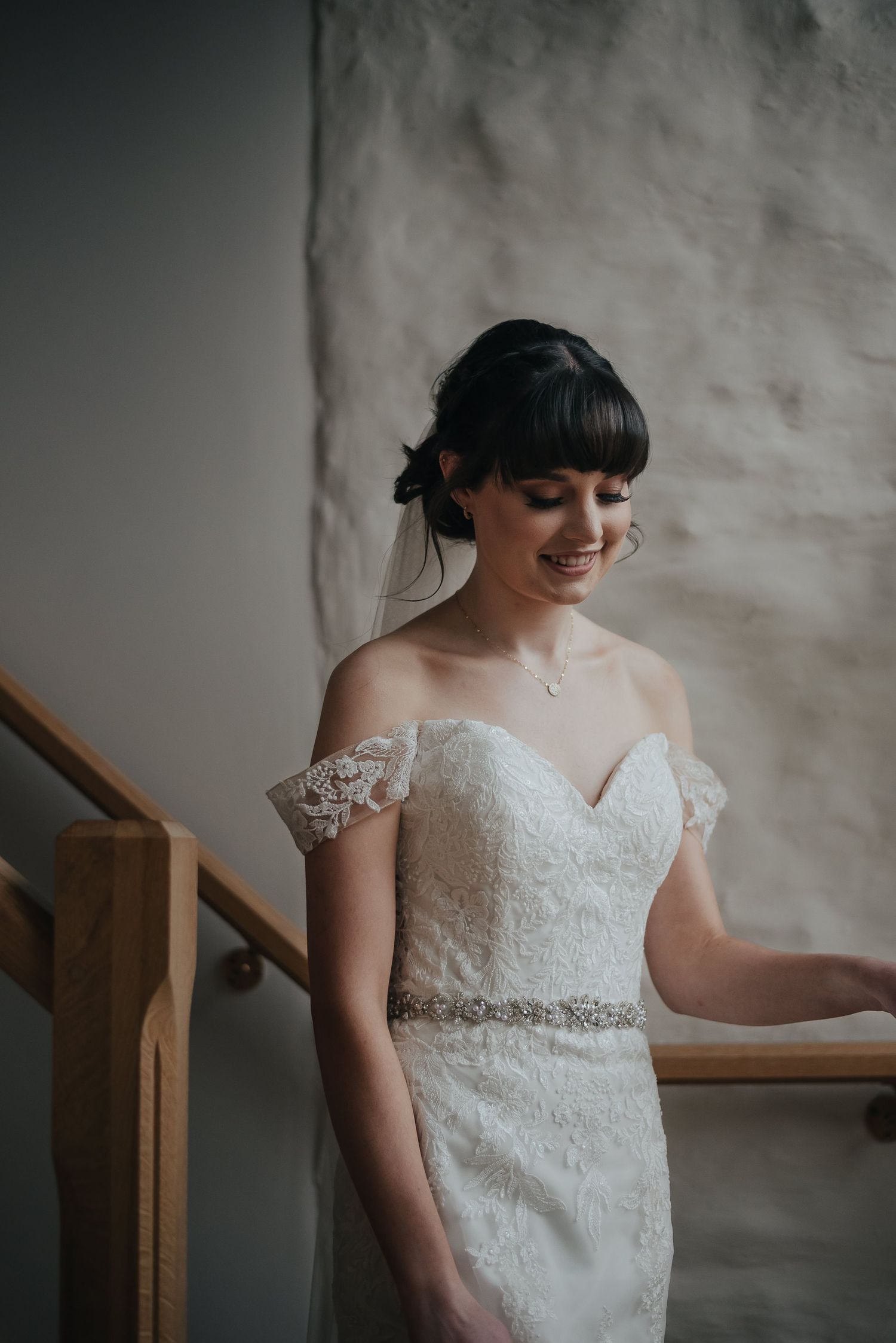 Elegant lace wedding dress with sweetheart neckline and beaded belt detail.