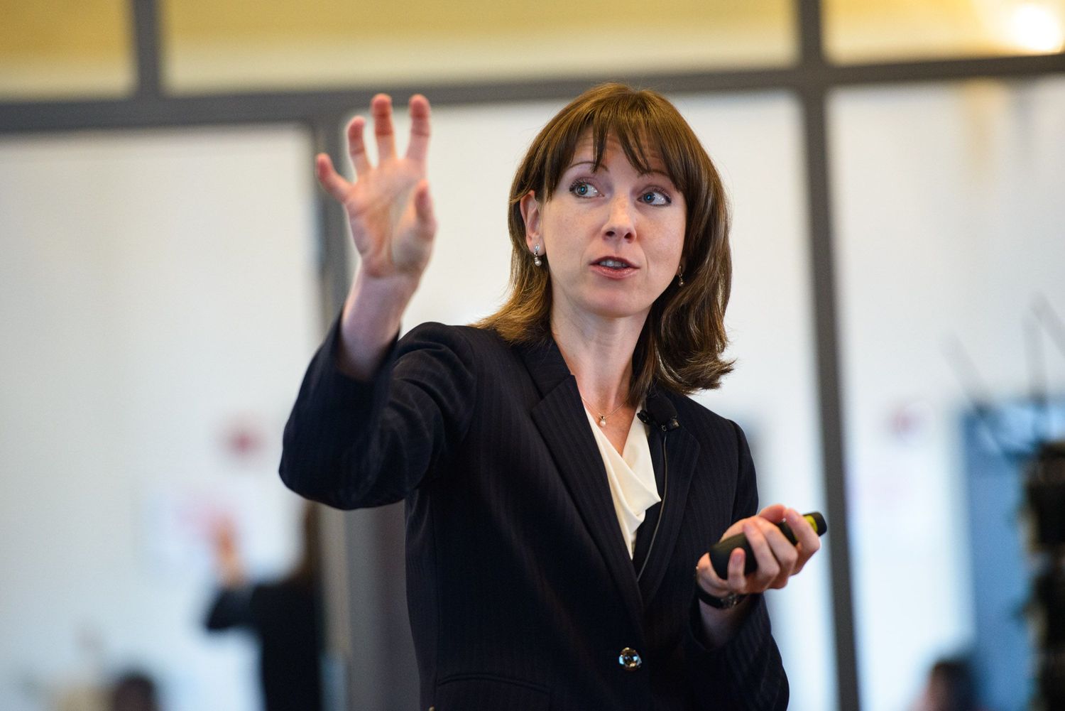 Business people engaged in animated discussion and gestures during a professional meeting.