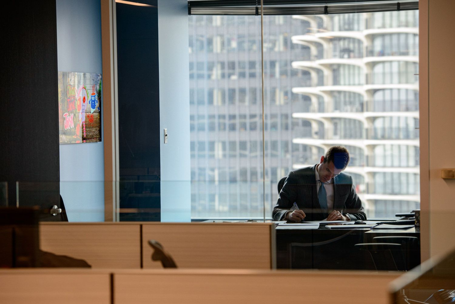 Corporate workspace with panoramic windows displaying downtown skyscrapers.