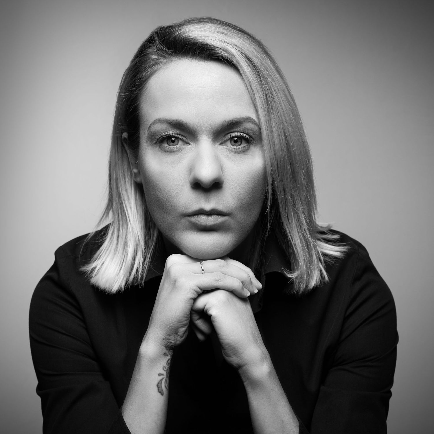 Artistic black and white photo sequence showing different poses of someone in dark clothing.