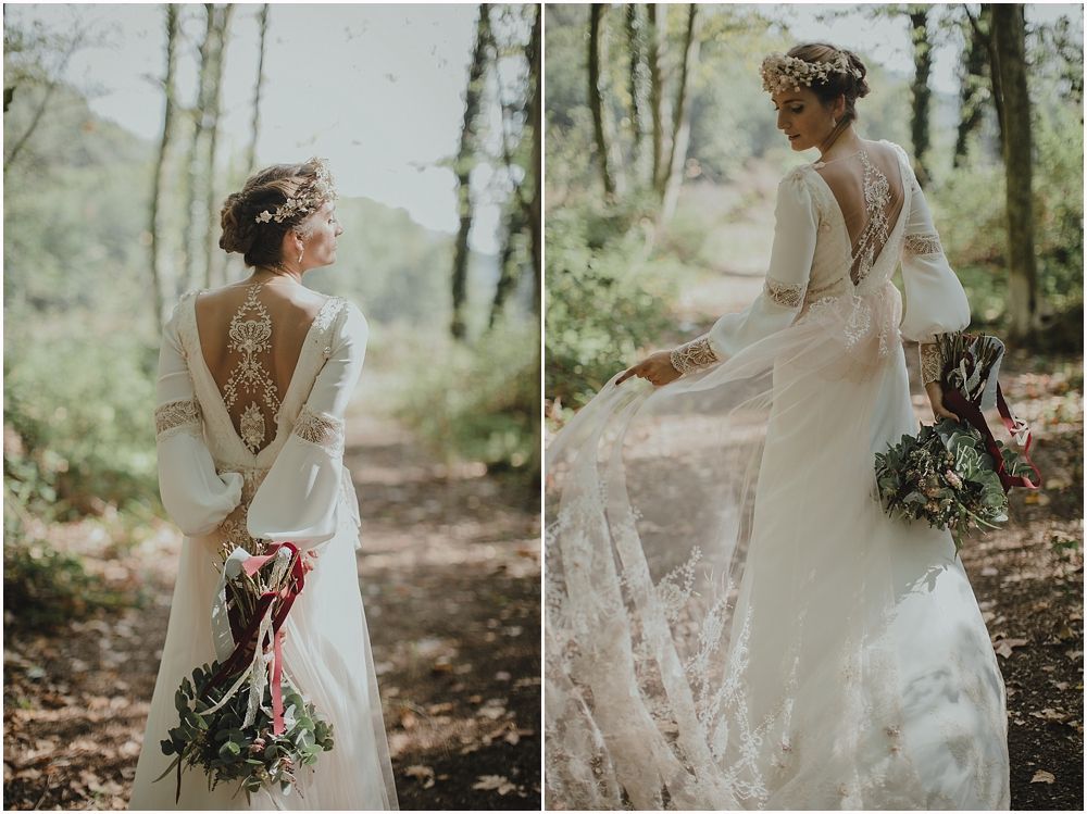Elegant vintage-style wedding dress with intricate lace back detail shown in forest setting.