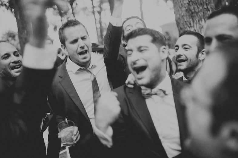 Group celebrating at formal event in black and white photography.