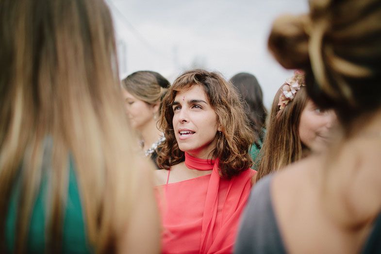 A guest in a coral dress enjoying the wedding festivities.