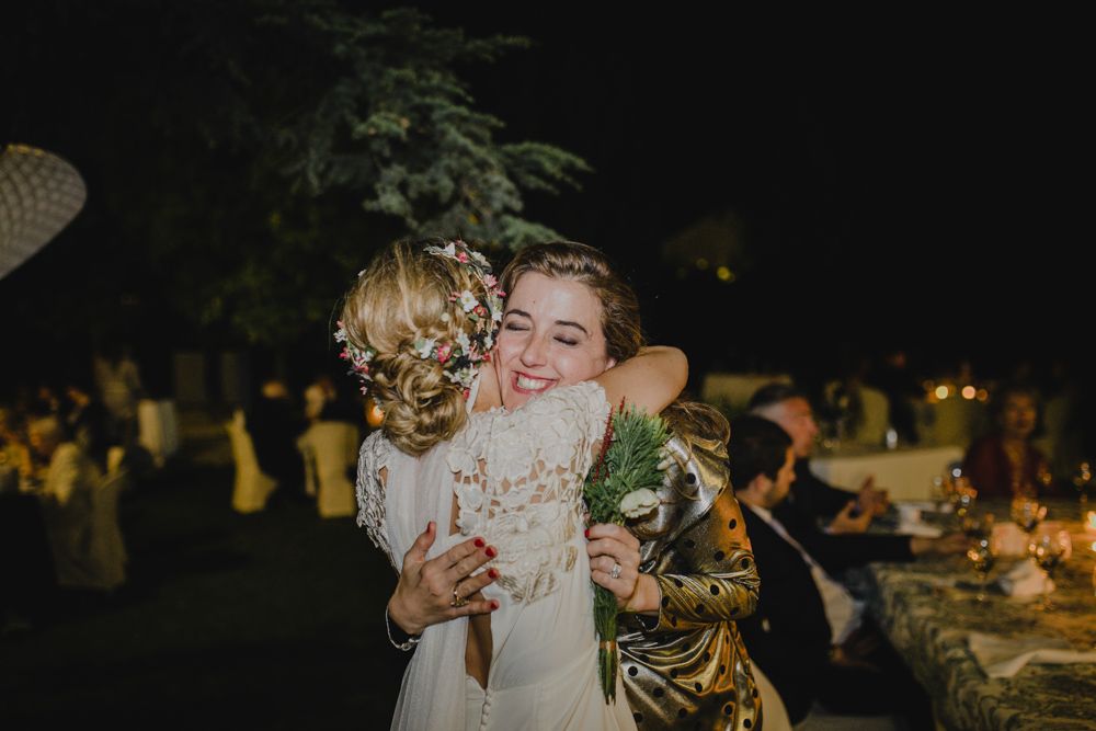 A joyful moment captured during a nighttime wedding celebration with dancing.
