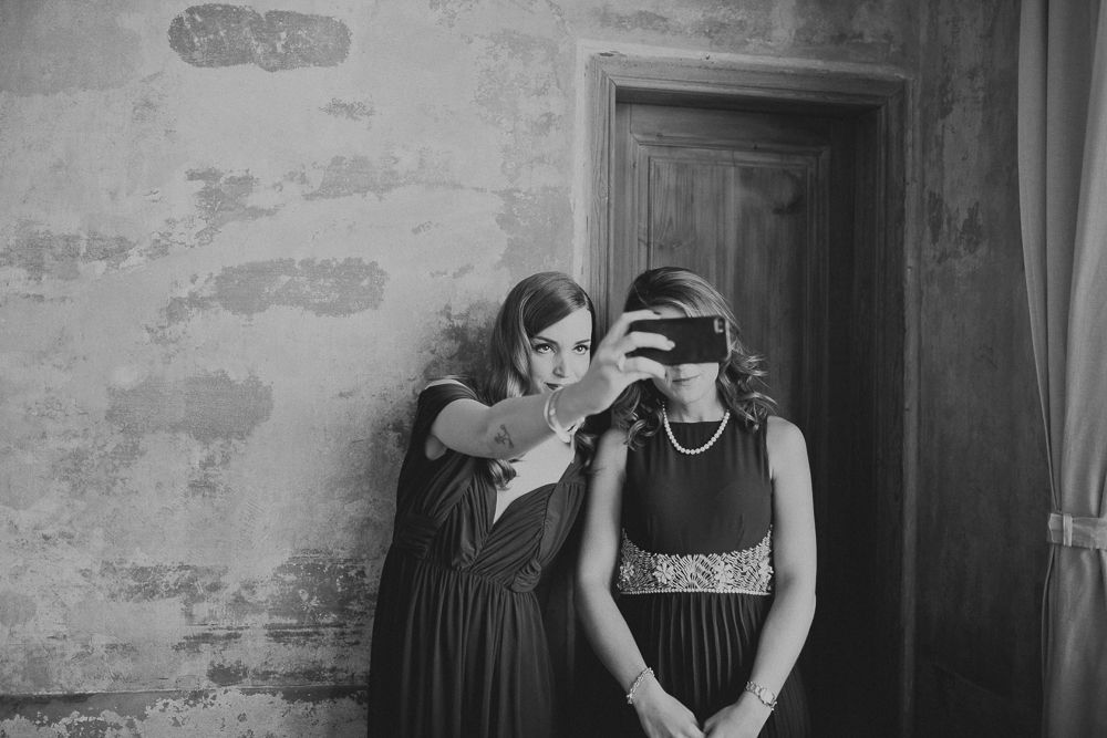 Two people sharing a moment while getting ready in a room with textured walls.