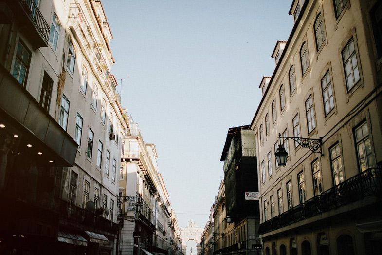 Historic European street with tall buildings and traditional architecture in soft lighting.