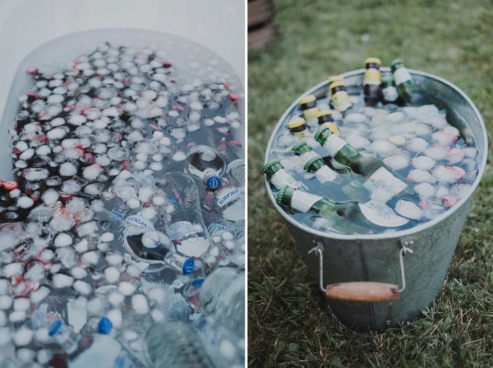 Metal tubs filled with drinks and ice at an outdoor event setup.