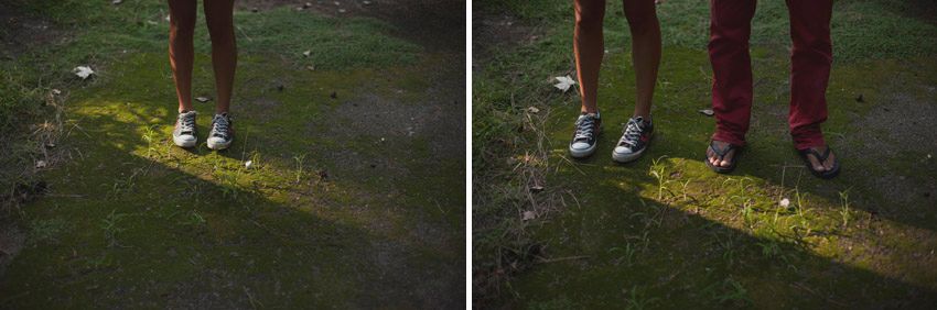 Two pairs of feet standing on grass illuminated by a bright spotlight.