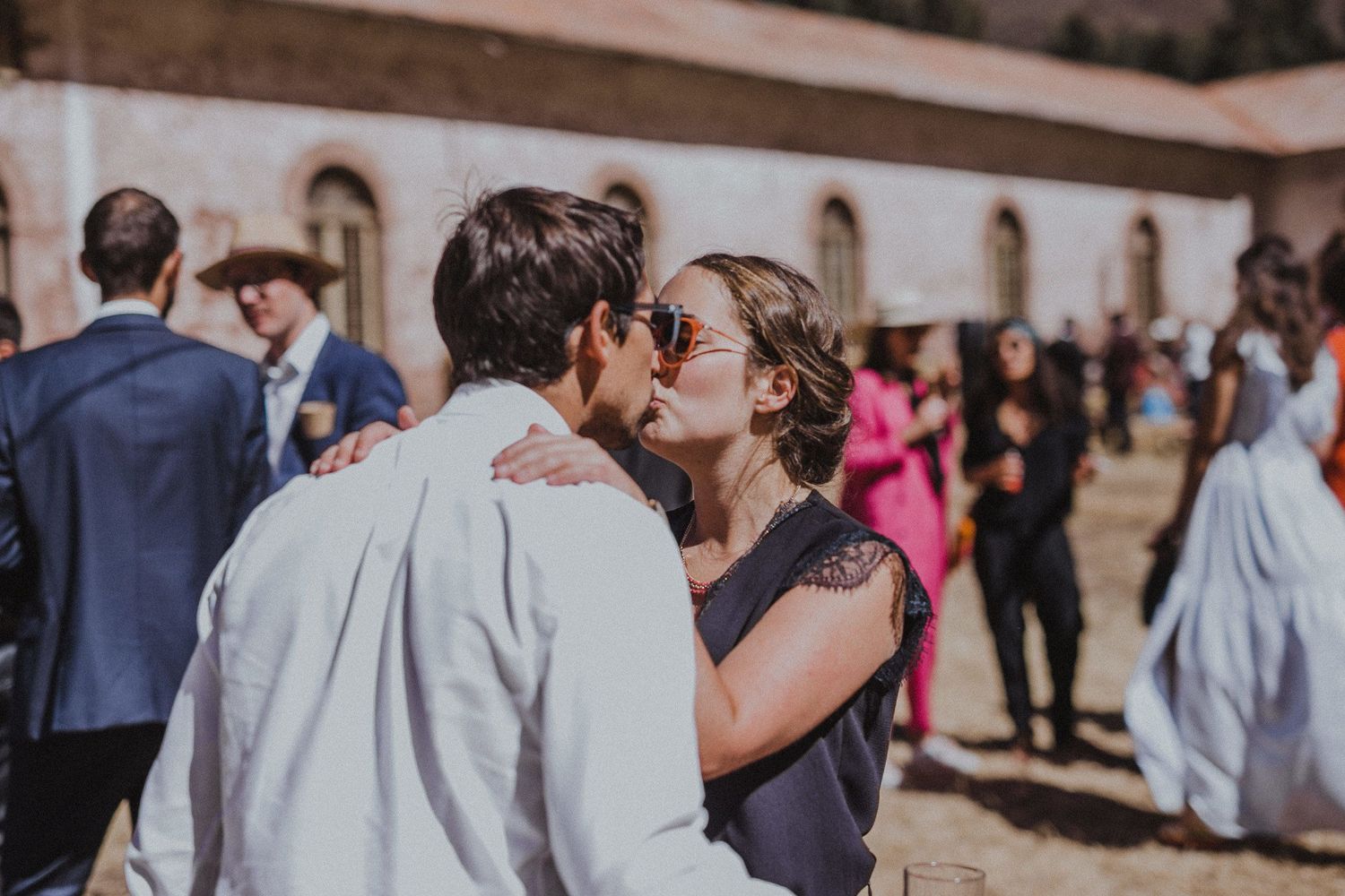 A tender moment shared between a dancing couple at an outdoor celebration.