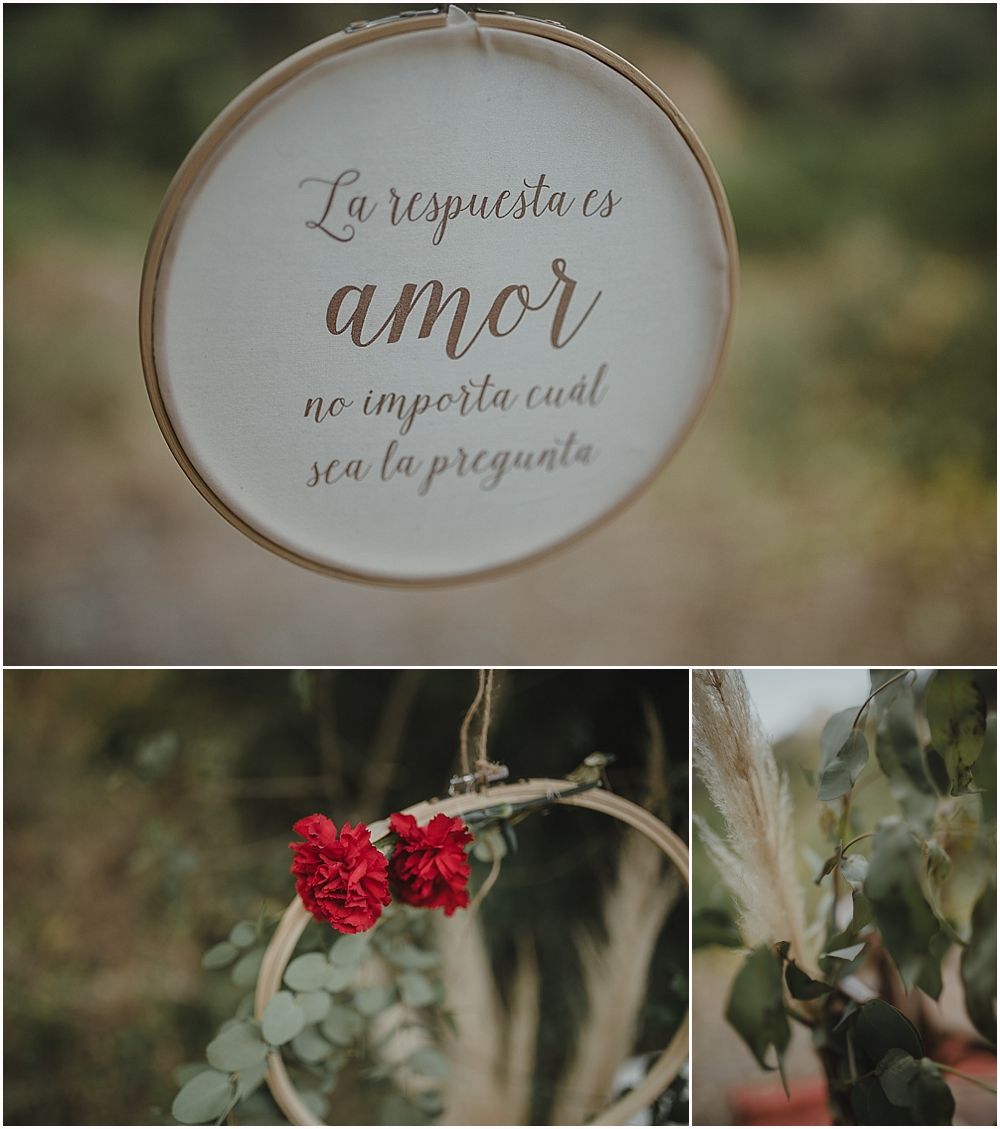 Spanish love quote in embroidery hoop with red flowers in nature setting.