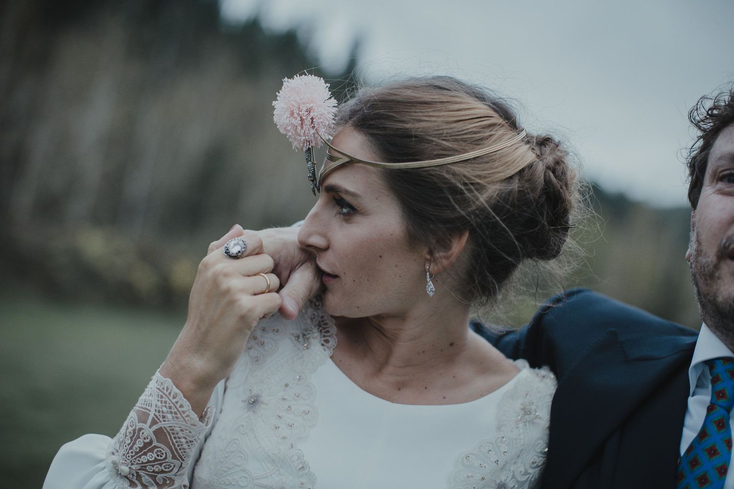 Close-up shot of an intimate wedding moment in an outdoor setting.