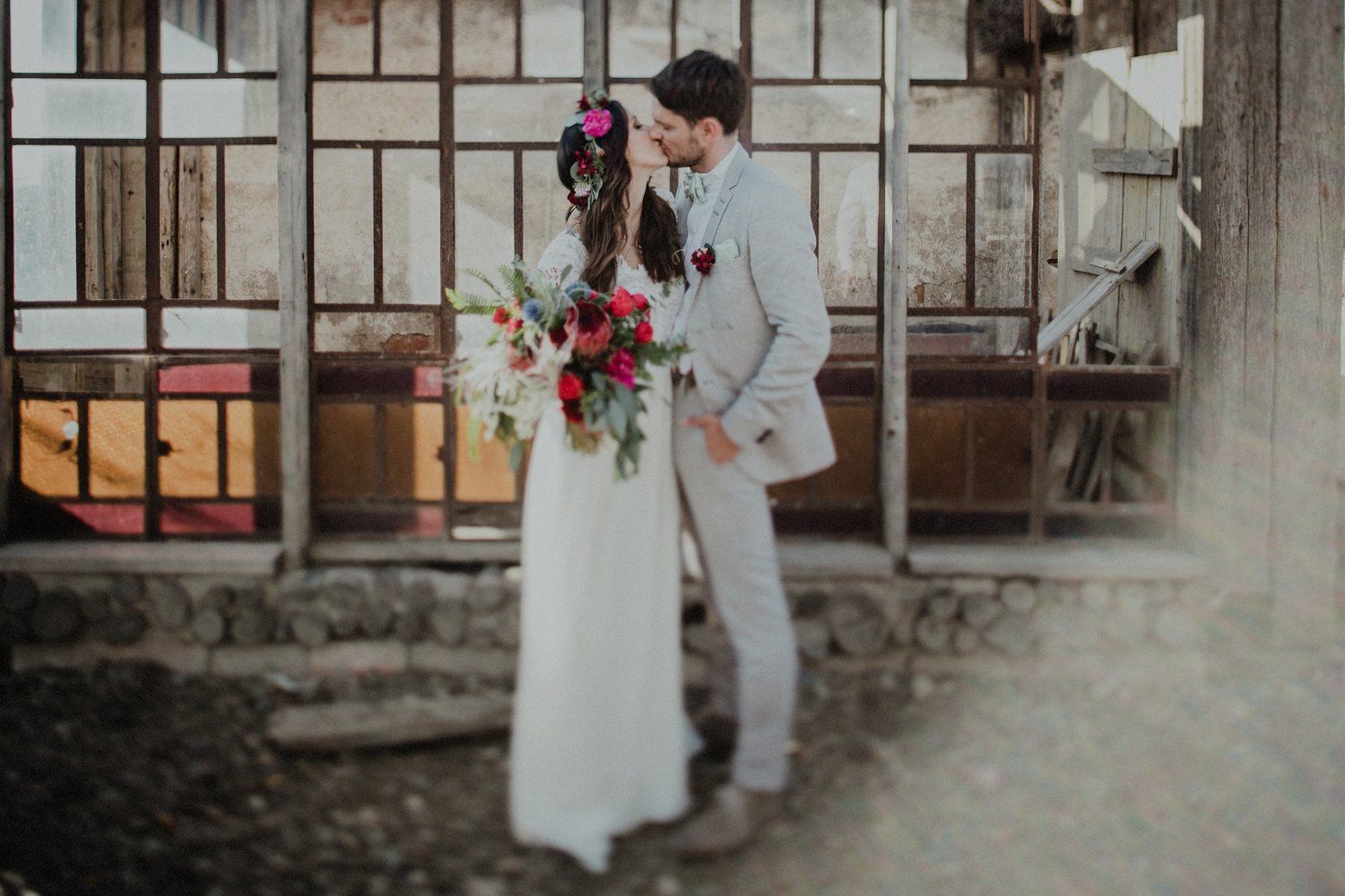 Romantic couple sharing an intimate moment in front of an industrial style window.