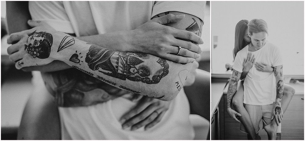 Detailed black and white close-up of tattooed arms showing intricate artistic designs.
