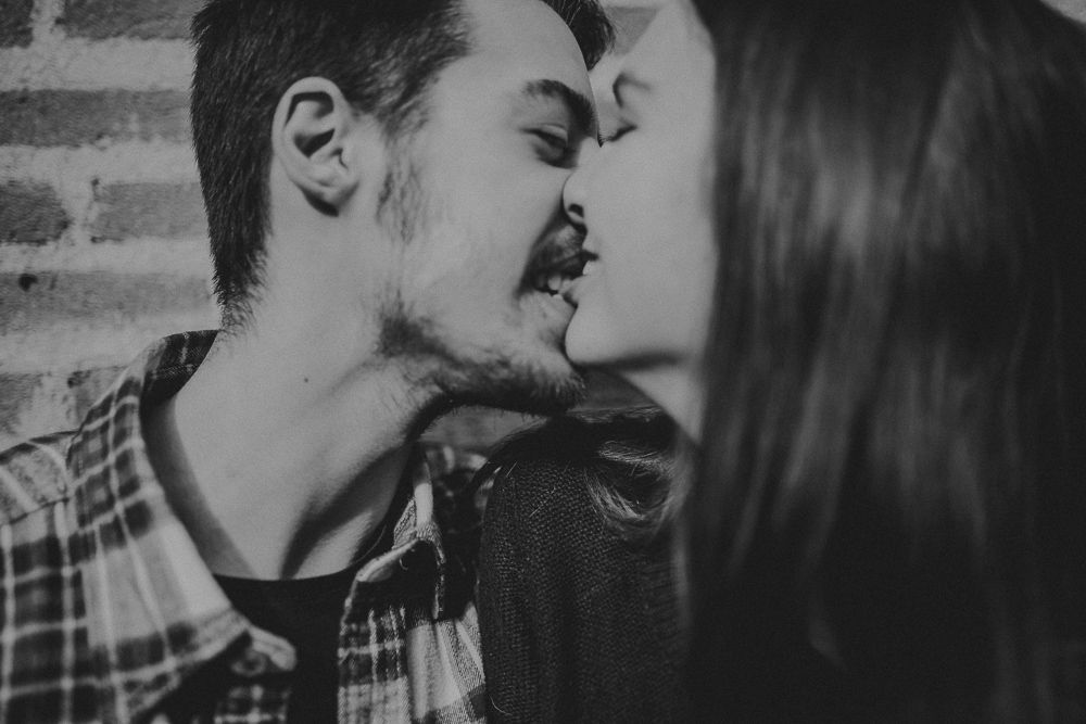 An intimate black and white close-up of a couple sharing a romantic moment.