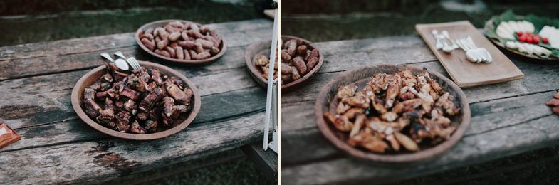 Rustic wooden tables displaying assorted nuts and dried fruits at wedding reception.