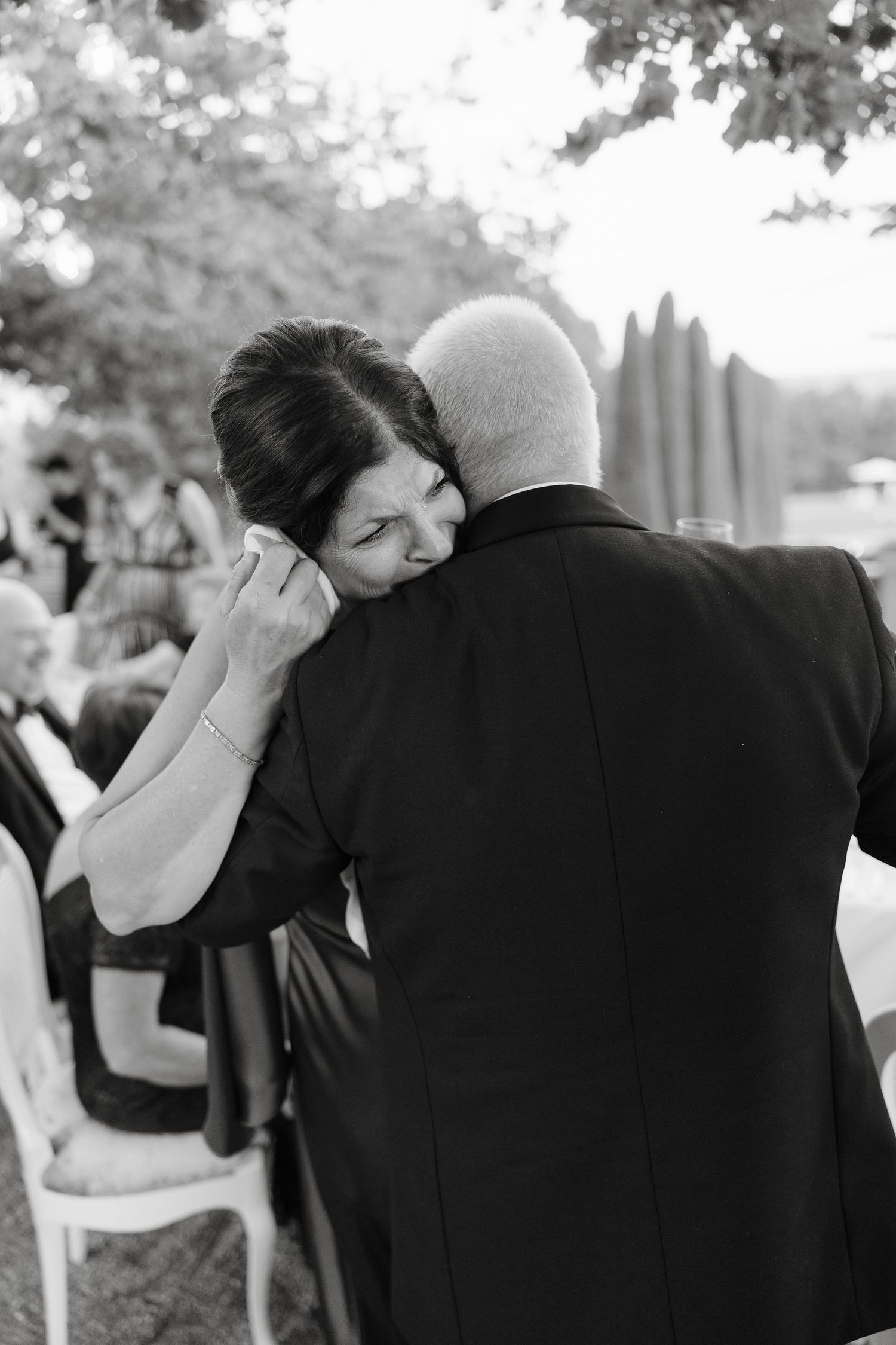 Emotional black and white moment during wedding reception.