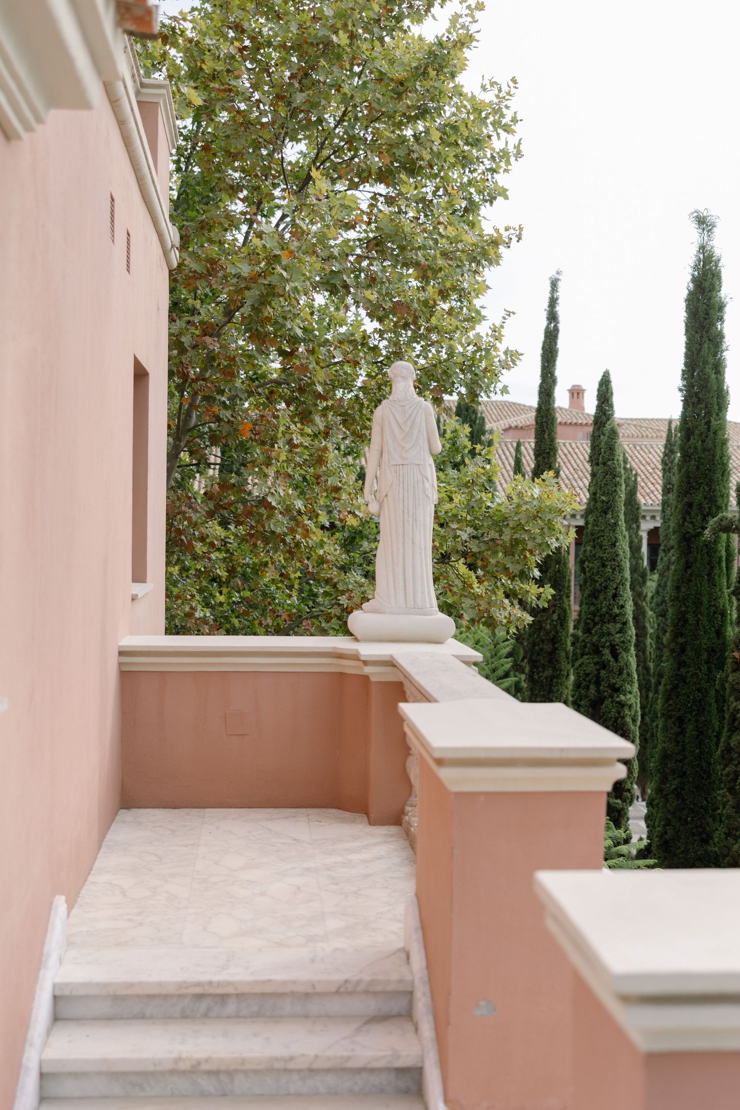 Pink terrace, marble balustrade and statue at Anantara Villa Padierna.