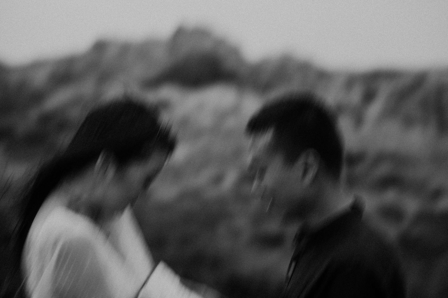 A blurred black and white moment between a couple outdoors.