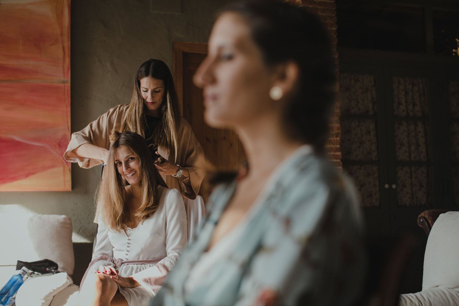 Intimate morning preparation scene with soft natural lighting in a rustic interior.