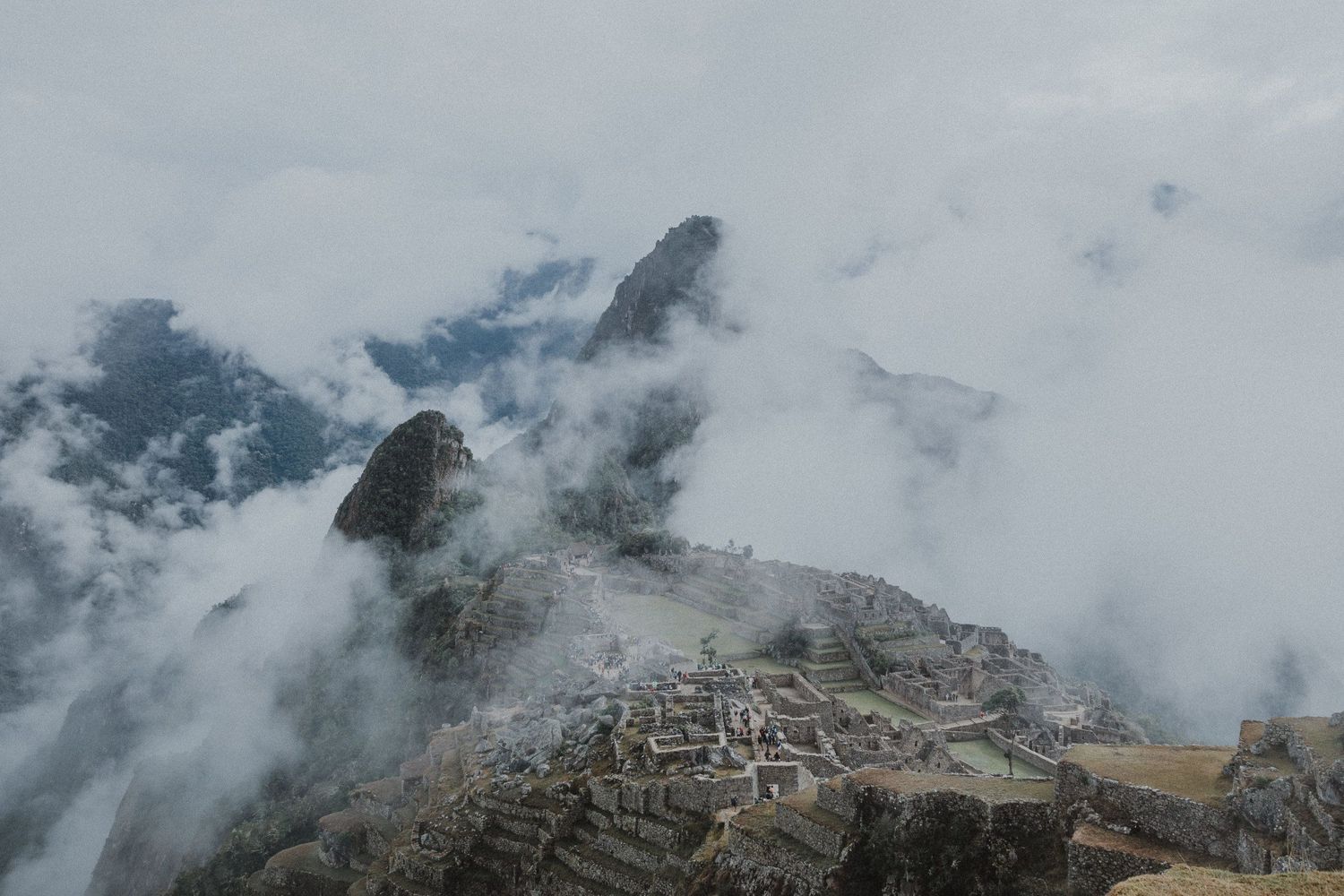 Ancient Machu Picchu ruins nestled in misty mountain peaks of Peru.
