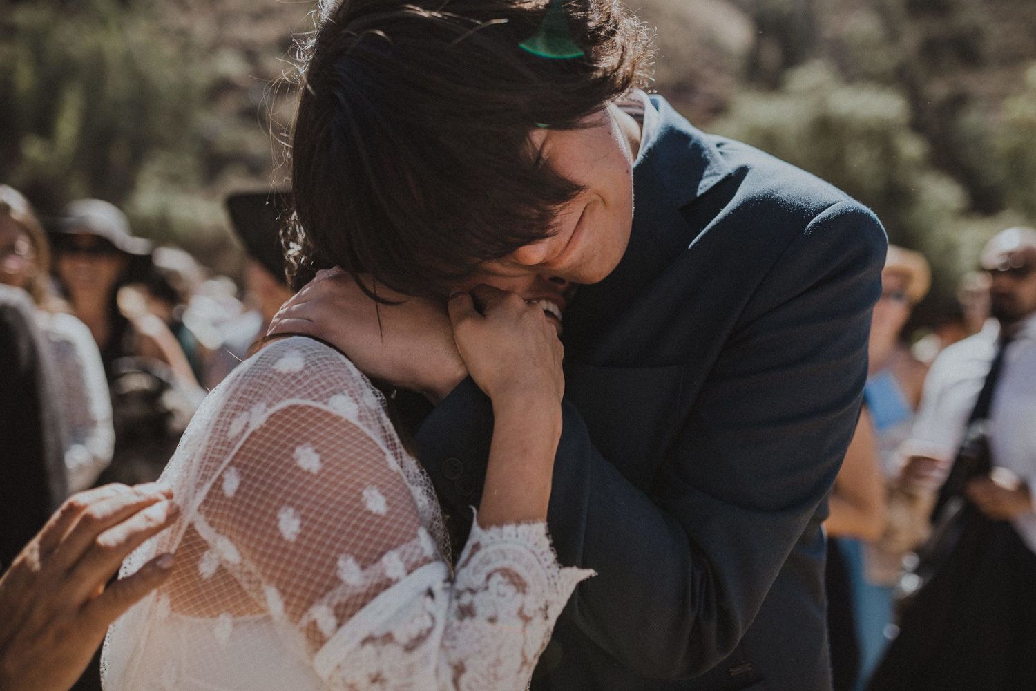 An intimate close-up moment between newlyweds during their outdoor wedding ceremony.