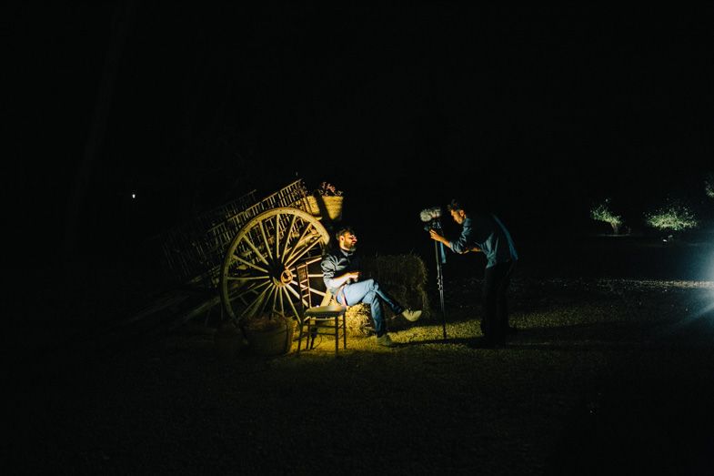 Illuminated carnival wheel creates magical lighting at nighttime wedding reception.