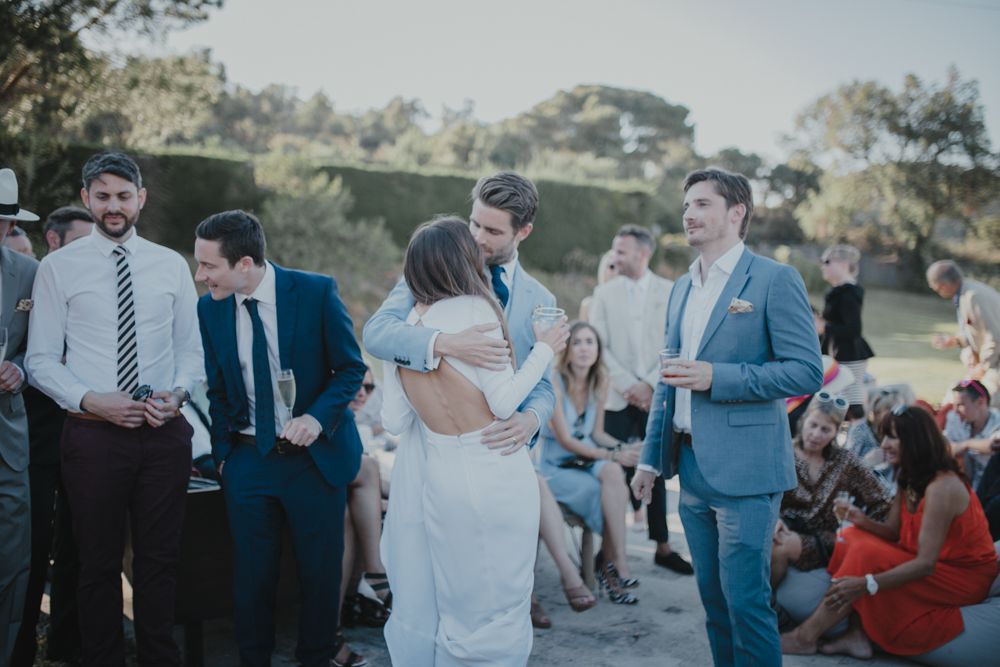 Wedding guests gathered outdoors enjoying a casual moment during the celebration.