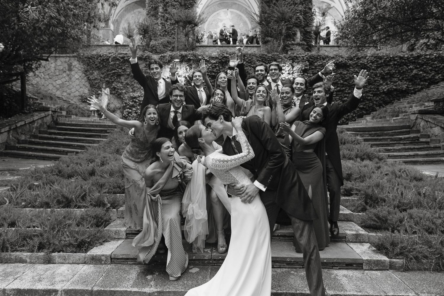 A black and white wedding photo collage showing candid moments of celebration and dancing at an outdoor venue.