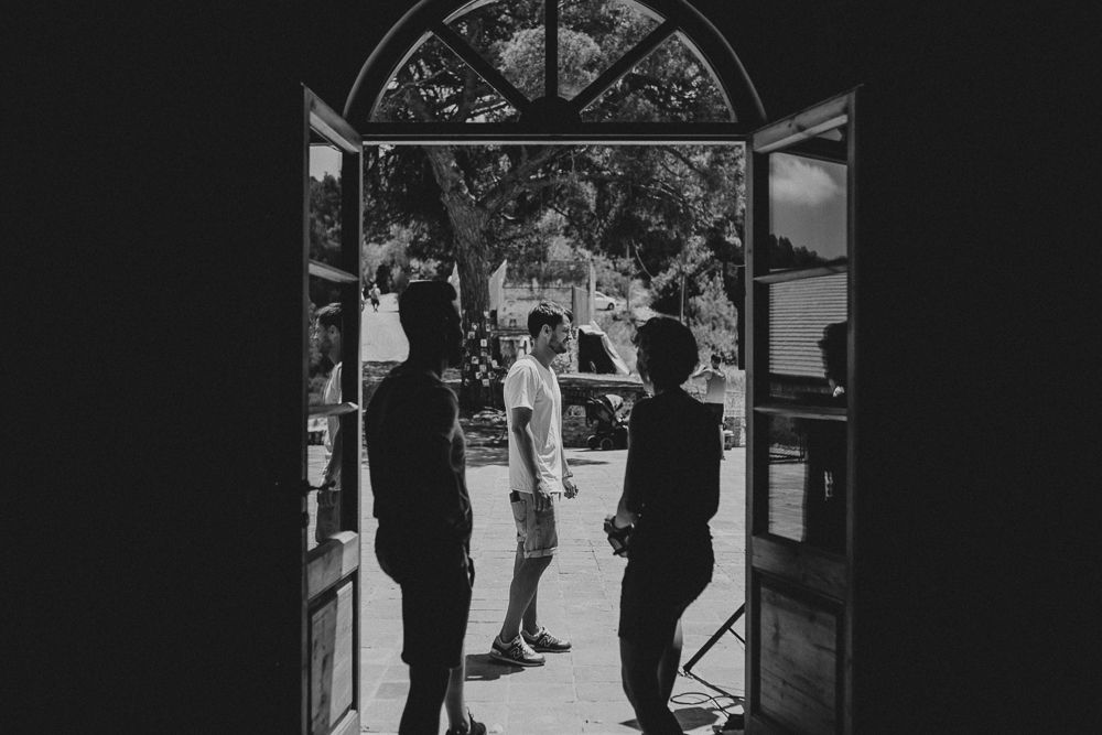 Black and white photo of people silhouetted in an arched doorway.