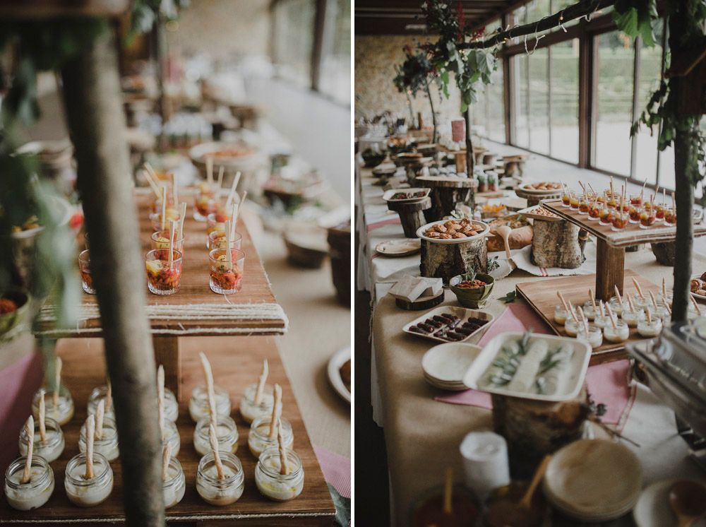 Elegant dessert display featuring rows of small appetizers and treats on wooden serving boards.