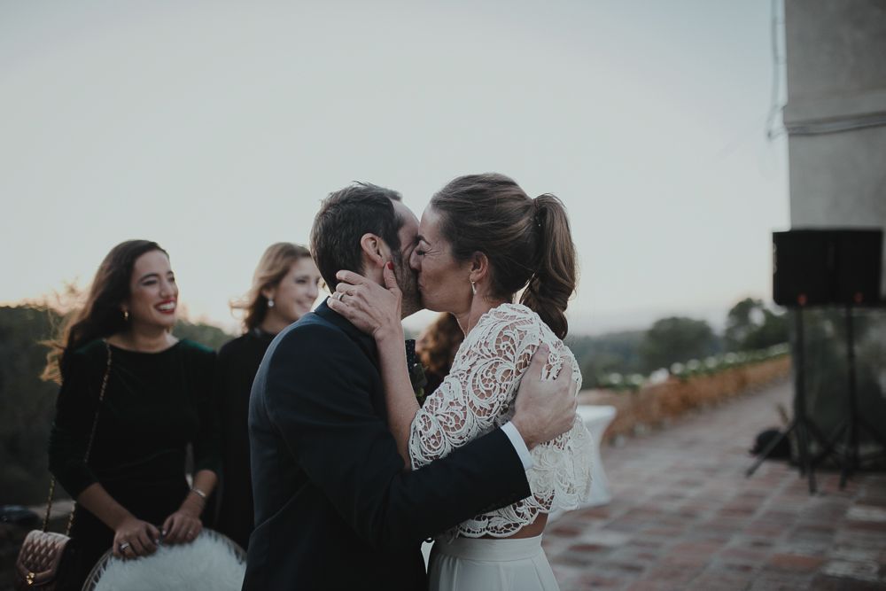 Romantic moment shared between couple during outdoor celebration.