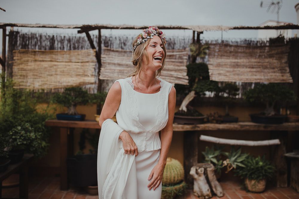 Joyful moment of pure laughter captured in an outdoor garden setting with natural lighting.
