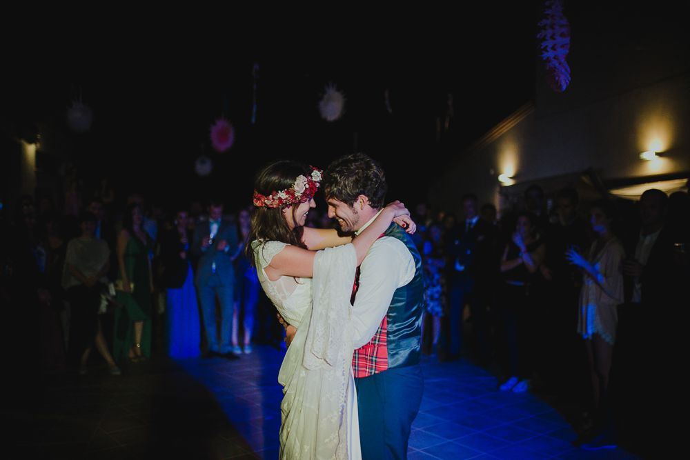 Intimate dance moment captured under dramatic blue lighting at an event.