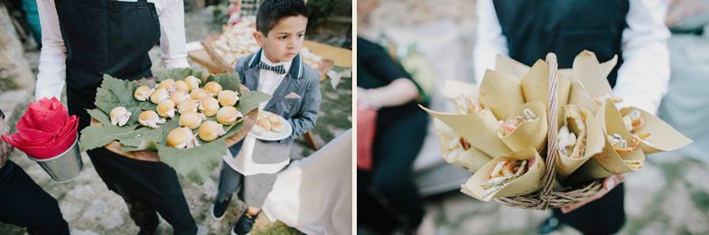 Wedding catering staff holding trays of elegantly presented hors d'oeuvres.