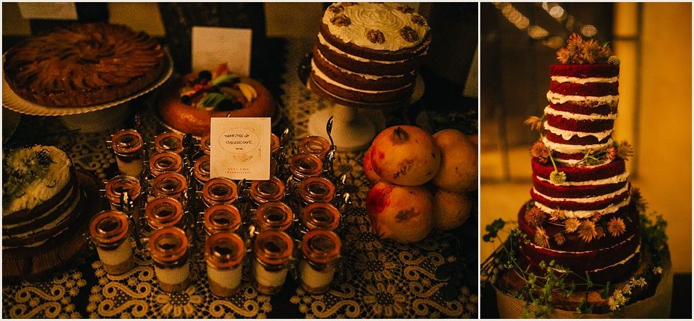 Rustic dessert table display featuring chocolate cakes and cupcakes with warm lighting.