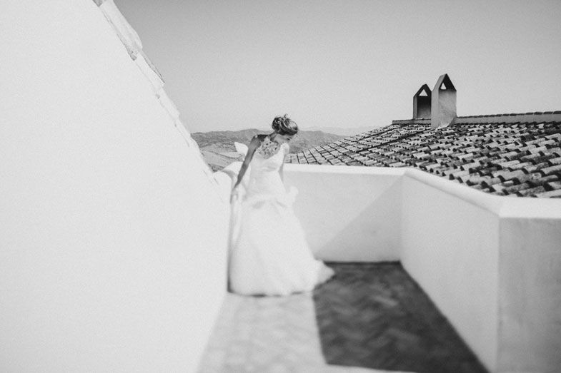 Wedding dress photographed on a Mediterranean white architecture rooftop.