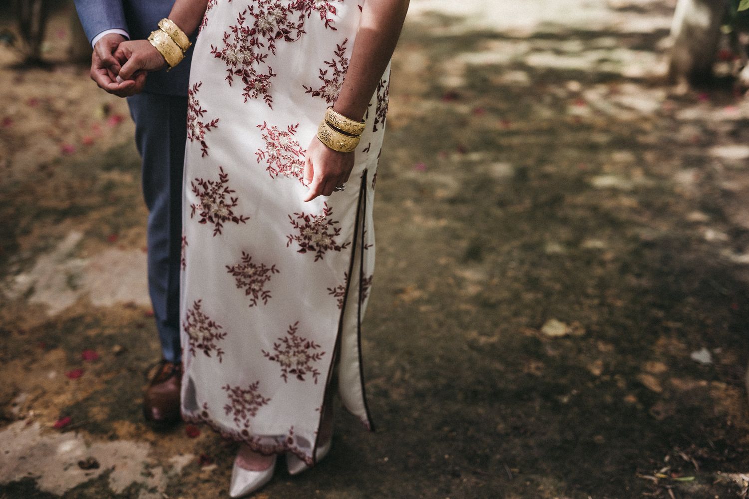 Close up of floral patterned traditional dress details in outdoor setting.