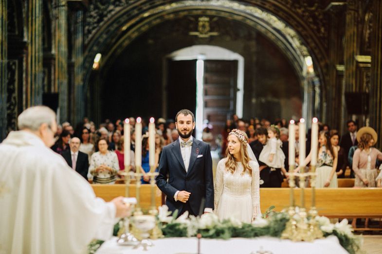 A couple stands before a priest during their traditional church wedding ceremony.