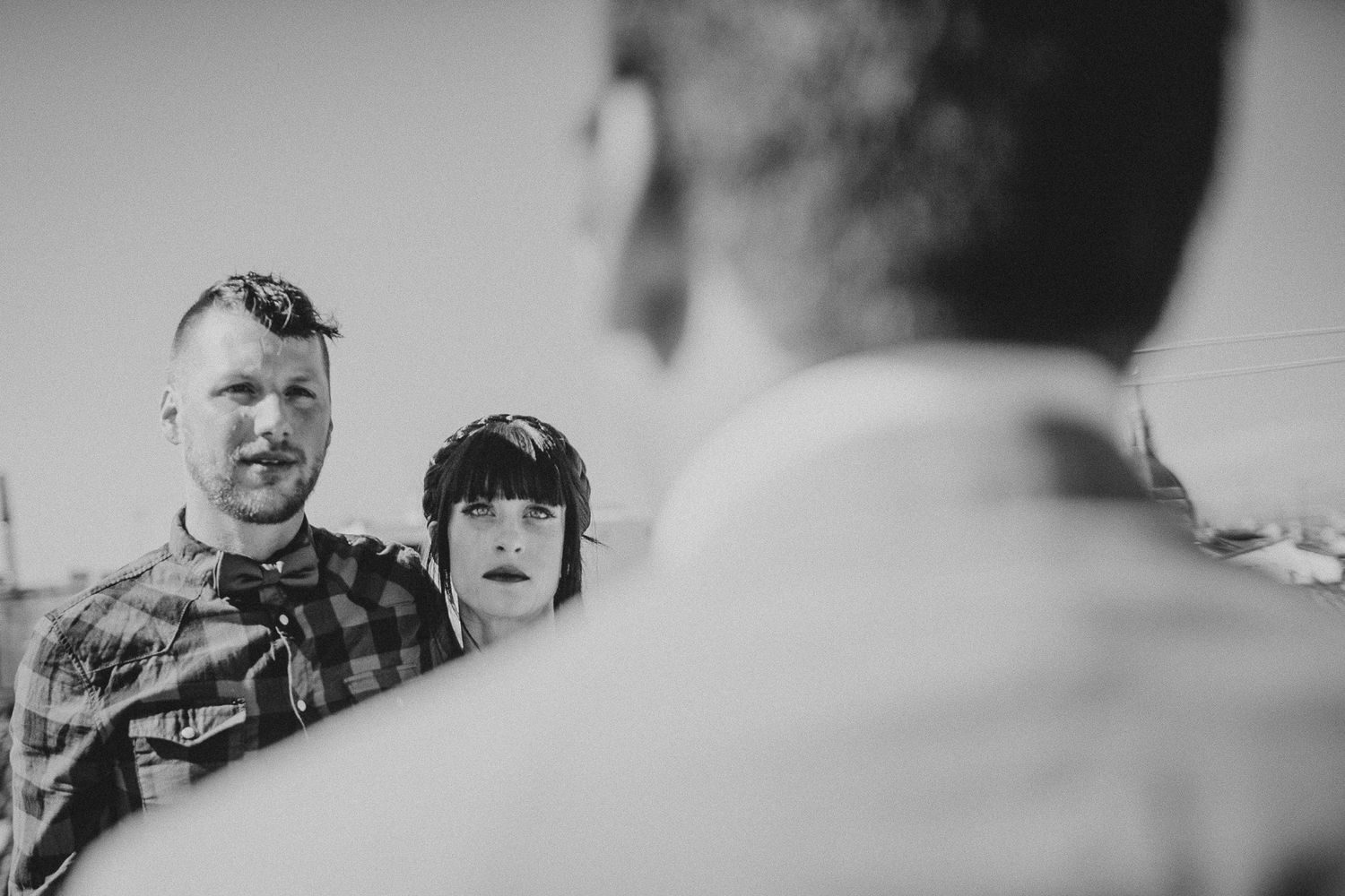 A black and white candid moment captured during a rooftop gathering.