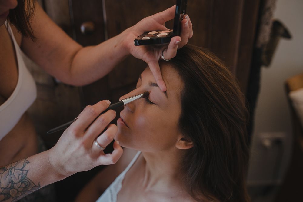 Behind the scenes shot of wedding makeup application in progress.