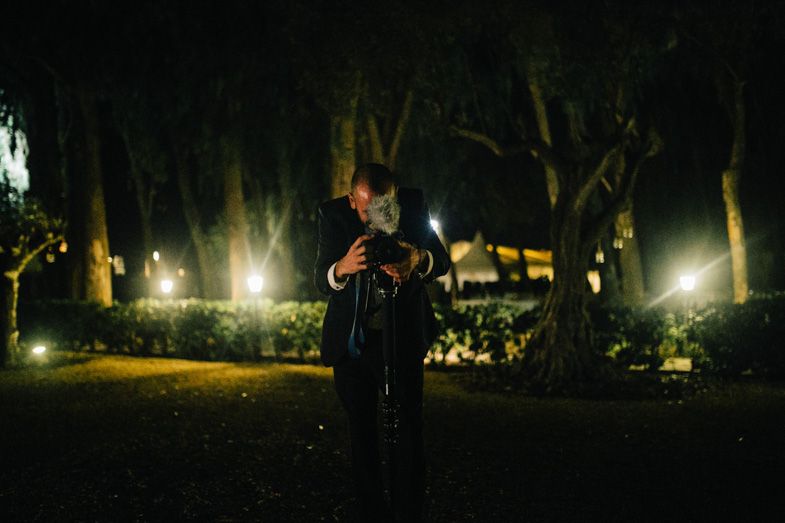 Atmospheric nighttime portrait in garden with string lights.
