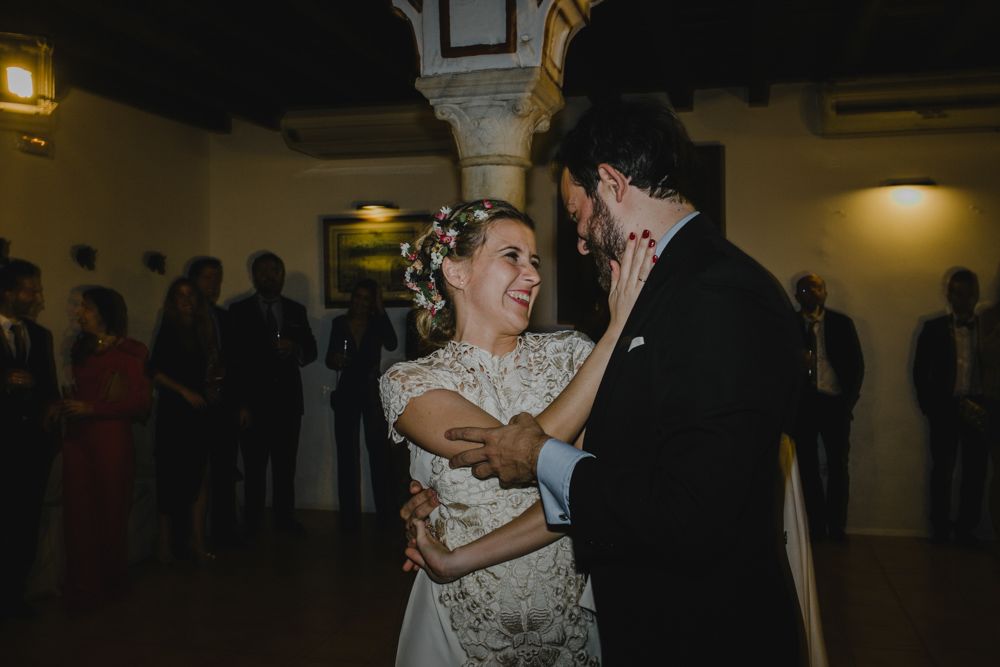 A couple shares a joyful dance moment at their wedding reception.