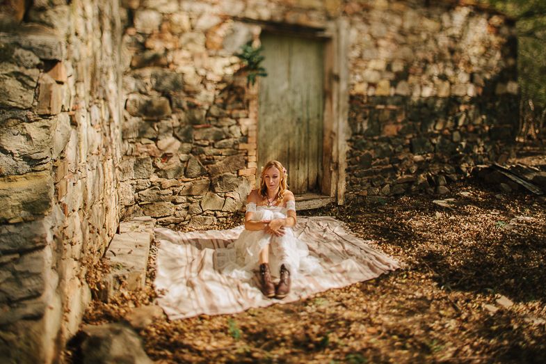 Outdoor bridal portrait against weathered stone wall and wooden door.